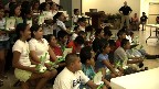 42 Immokalee children pose with their new XOs